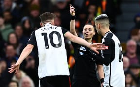 English referee Rebecca Welch (C) gestures during the English Premier League football match between Fulham and Burnley at Craven Cottage in London on December 23, 2023. Rebecca Welch becomes the first female referee of a Premier League match overseeing Fulham's game against Burnley. (Photo by HENRY NICHOLLS / AFP) / RESTRICTED TO EDITORIAL USE. No use with unauthorized audio, video, data, fixture lists, club/league logos or 'live' services. Online in-match use limited to 120 images. An additional 40 images may be used in extra time. No video emulation. Social media in-match use limited to 120 images. An additional 40 images may be used in extra time. No use in betting publications, games or single club/league/player publications. /