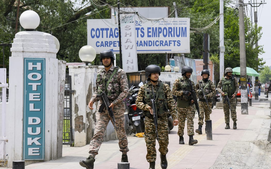 Indian security forces patrol a road near Dal Lake in Srinagar, India, on 6 May, 2025. Increased military presence follows the 22 April attack on tourists in Pahalgam, amid rising tensions between India and Pakistan.