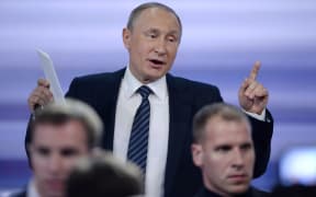 Russian President Vladimir Putin gestures as he leaves a hall after his annual press conference in Moscow on December 17, 2015. Russian President Vladimir Putin on December 17 described US Republican presidential hopeful Donald Trump as a talented and outstanding man.