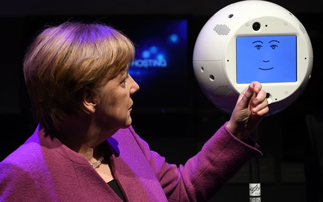 German Chancellor Angela Merkel looks at CIMON during a space exhibition in April.