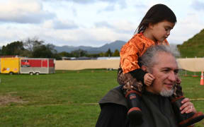 Poia Rewi with his mokopuna Poia Paku on his shoulders.