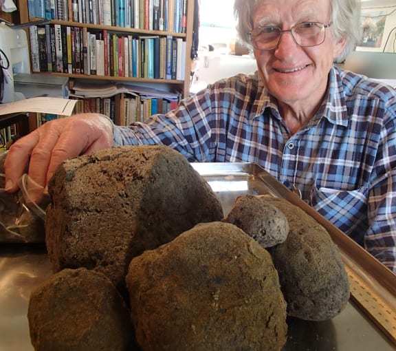 Archaeologist Bruce McFadgen with some of the pumice found in a thick layer in peat on the Kapiti Coast, which varies in size from 2 mm to 30 cm.