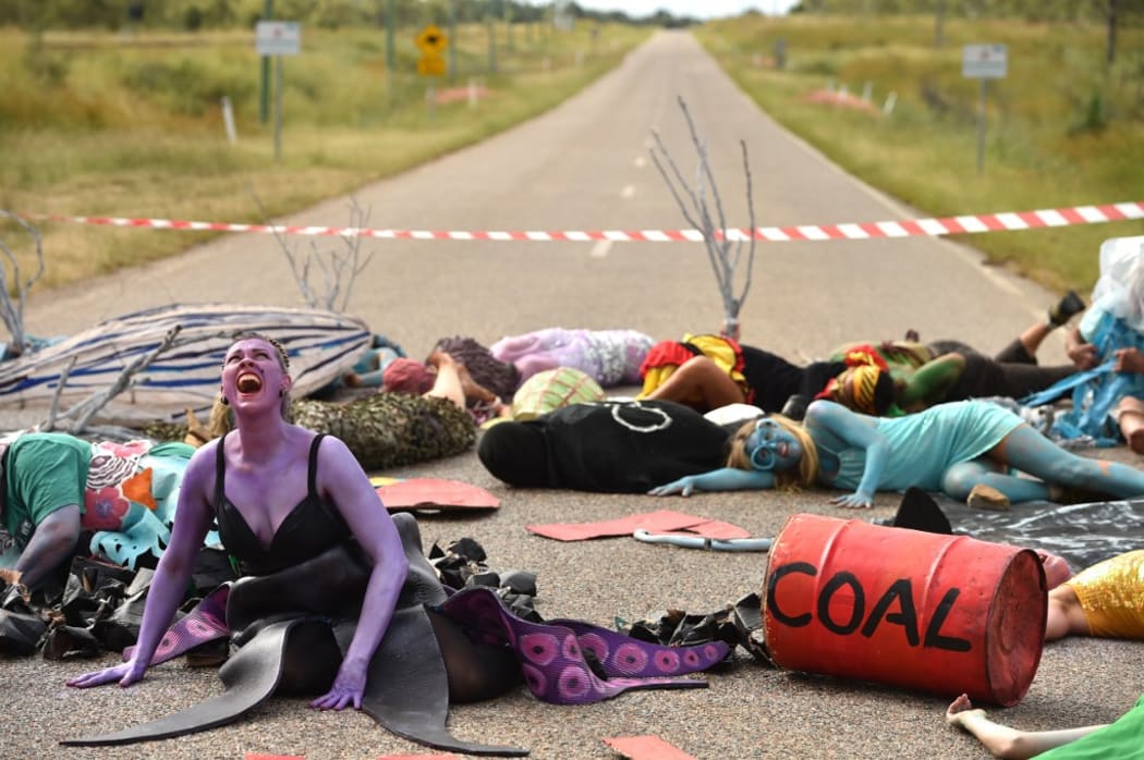 Environmental campaigners holding a protest against the development of the India-backed Adani coal mine.