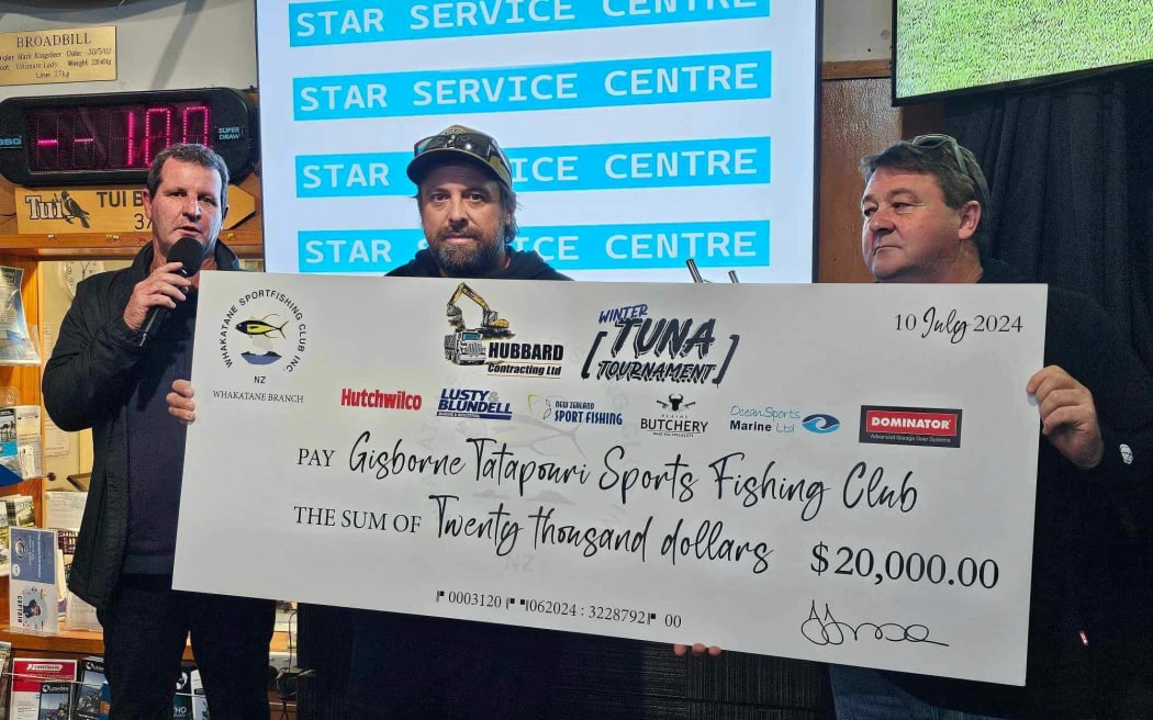 Members of the Whakatāne Fishing Club present a $20,000 cheque to Tatapouri Fishing Club president Roger Faber (left) which will be donated to the whānau of three fishermen who died at sea last month.