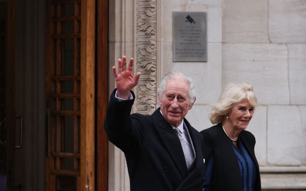 Britain's King Charles III (L) waves as he leaves, with Britain's Queen Camilla,  the London Clinic, in London, on January 29, 2024. Britain's King Charles III, 75, stayed the London Clinic following prostate surgery on January 26, 2024. (Photo by Adrian DENNIS / AFP)