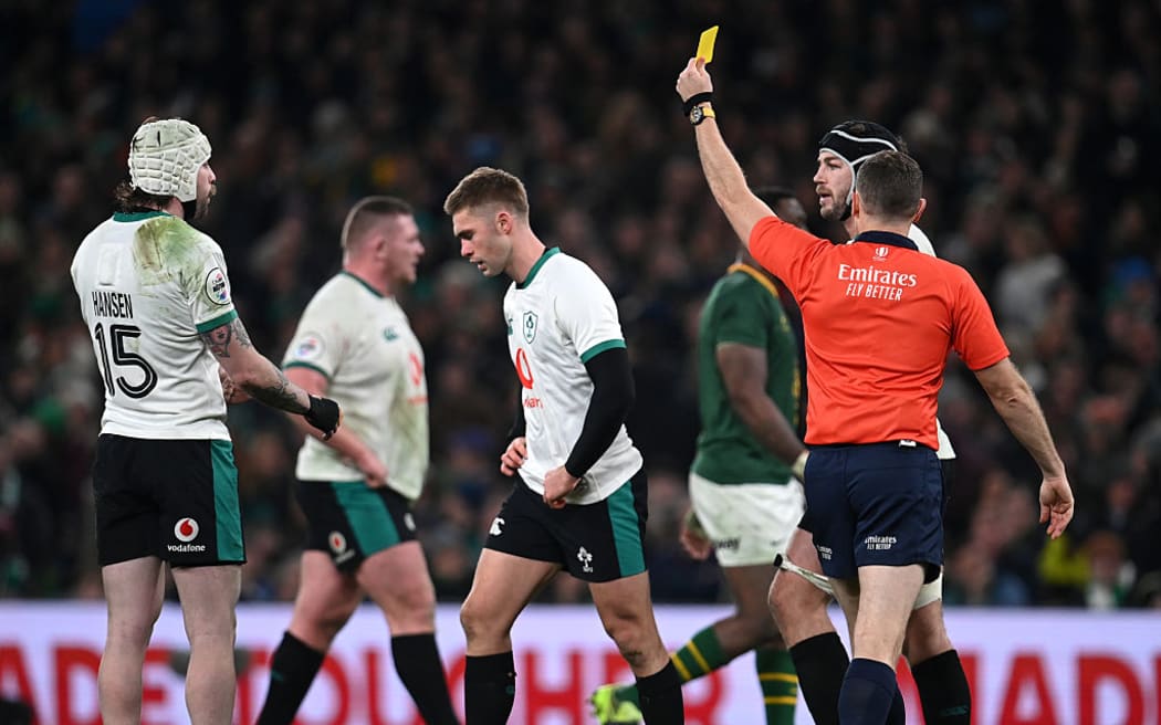 Jack Crowley of Ireland is shown a yellow card by referee Matthew Carley during the Quilter Nations Series 2025 match between Ireland and South Africa at the Aviva Stadium.