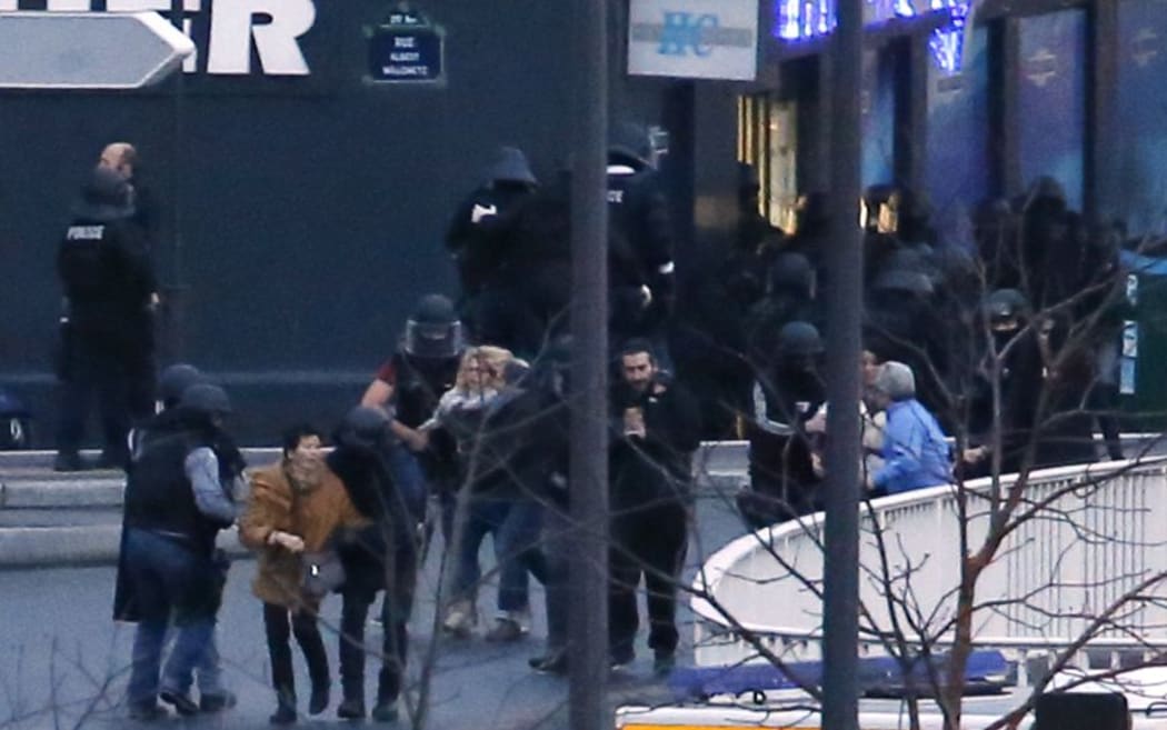Members of the French police special forces evacuate the hostages after launching the assault in Paris.