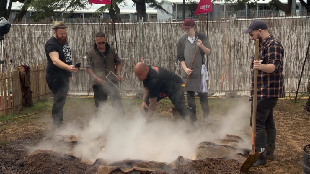 Rewi Spraggon, centre, guides chefs in the art of hangi making.