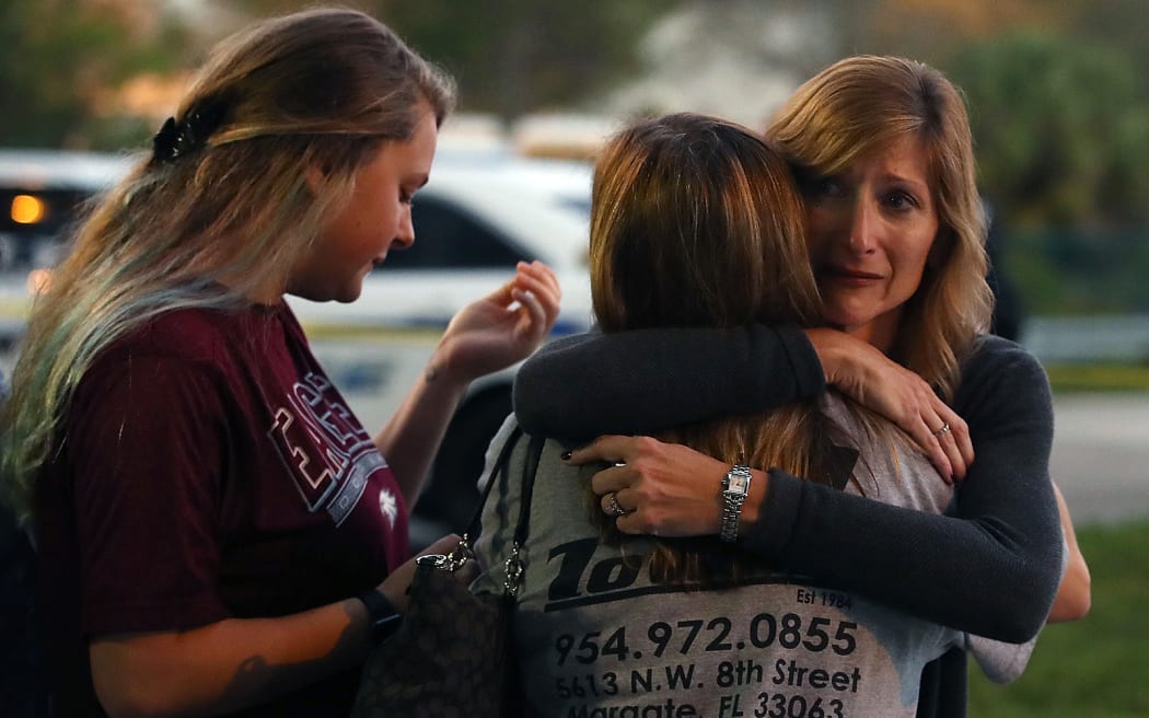 A hug at a police check point near the Marjory Stoneman Douglas High School after the shooting.
