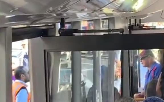 The replacement bus driver argues with people participating in industrial action.