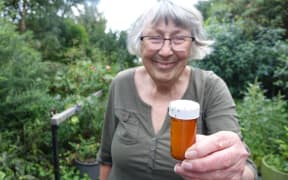 Jenny Scott holds a trap with ants.