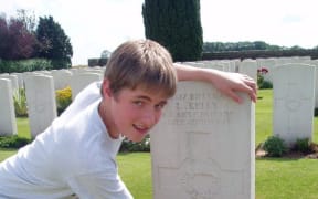 A photo showing Robert Kelly, aged 16, at his great-great uncle's grave at Vaulx Hill Cemetery in France, June 2007