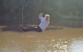 Whanganui Mayor Hamish takes a ceremonial swing over the river.