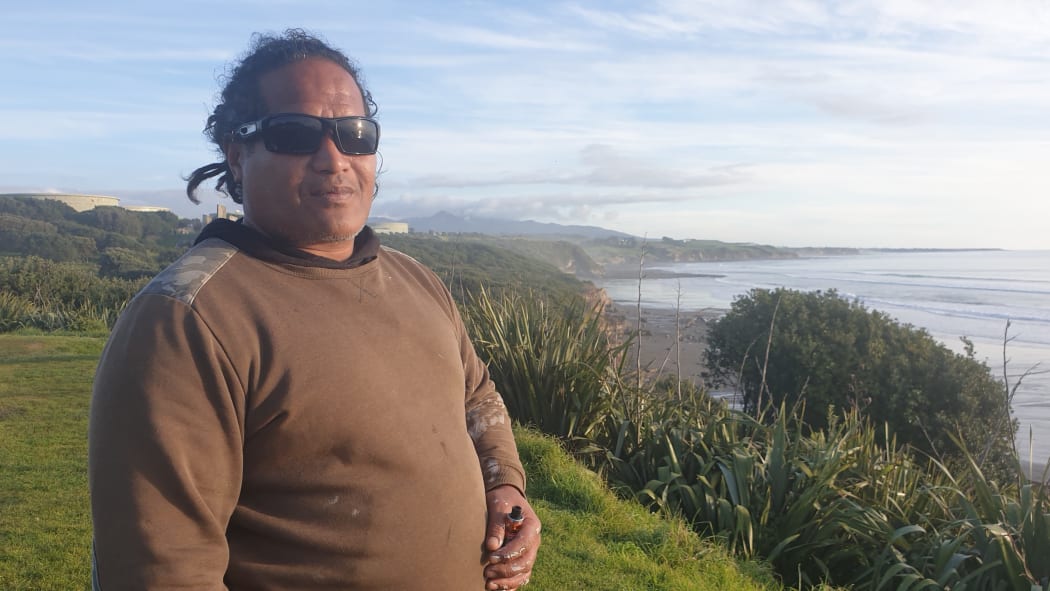 Surfer Tama Liunaihetau checks out the conditions at Onuku Taipari / Back Beach in New Plymouth.