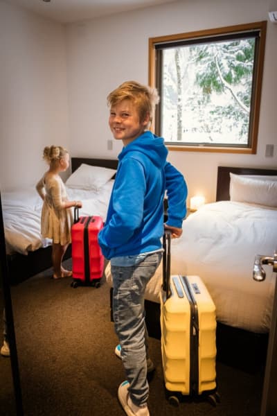 Jen Parkes' children carry their luggage to their accommodation.