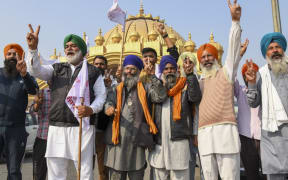 Farmers shout slogans to celebrate after India's Prime Minister announced to repeal three agricultural reform laws that sparked almost a year of huge protests across the country in Amritsar on November 19, 2021.