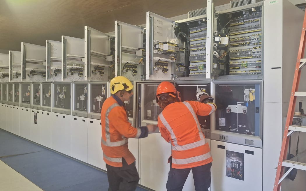 Top Energy staff get the replacement switchboard panel ready for installation.