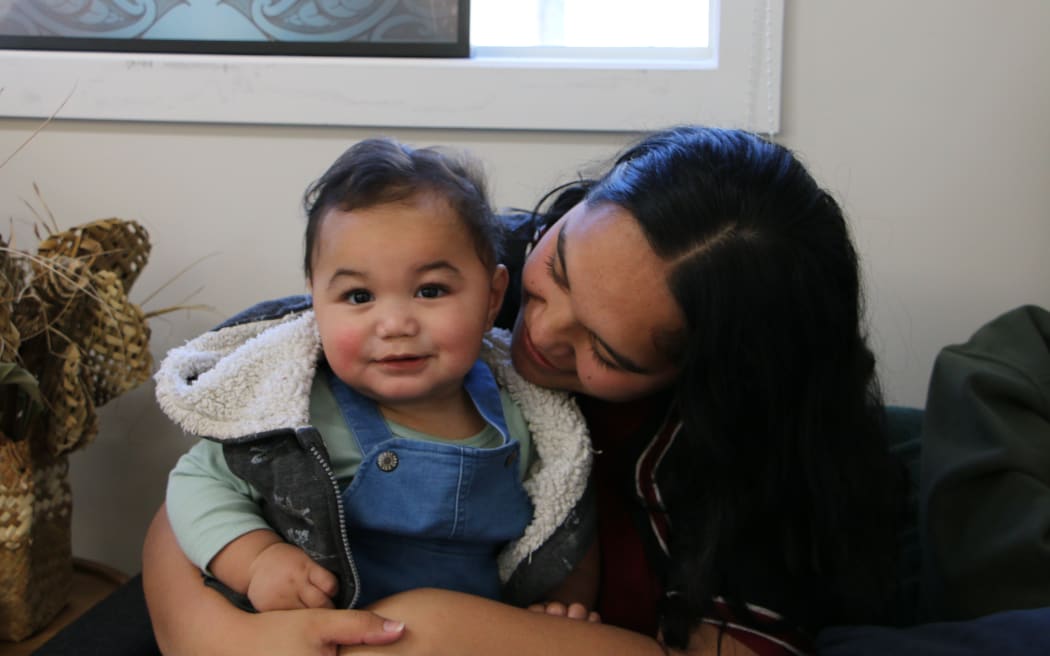 Katrina Kepa and her 10-month-old son Jazahrn at the opening of Te Whare Piringa, a new iwi-led kaupapa Māori space offering dedicated support to mātua taiohi (young parents) and whānau.