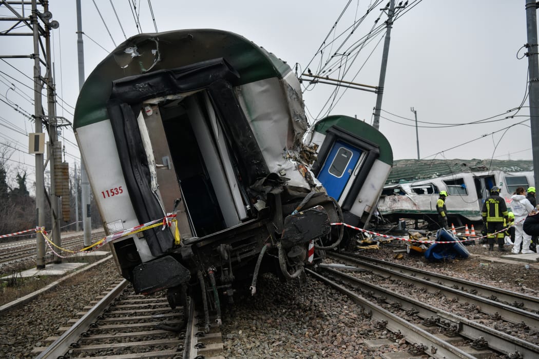 Italian rescuers, police and technicians work on the site of a train derailment, on January 25, 2018 near Milan.