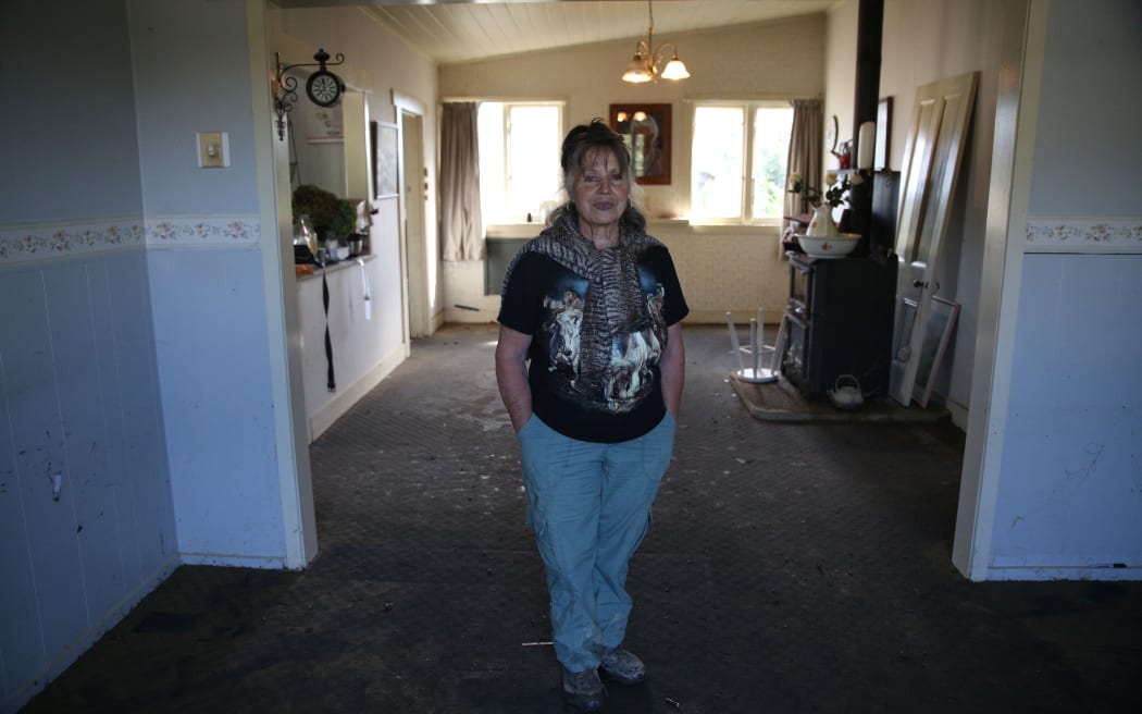 Jeanette Mitchell inside her flood-damaged house.