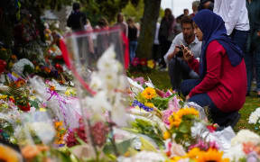 People laying flowers in Christchurch after the mosques shootings.