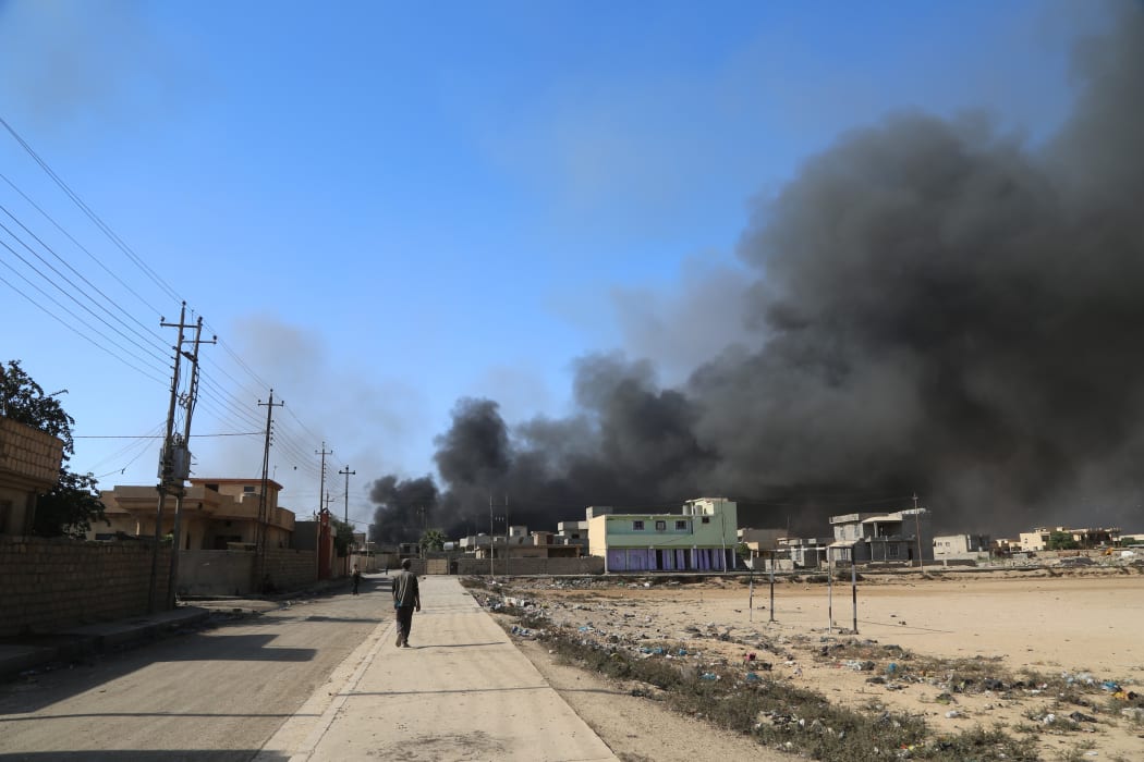 Smoke rises after Islamic State terrorists set oil wells on fire during an Iraqi army operation to retake Mosul.