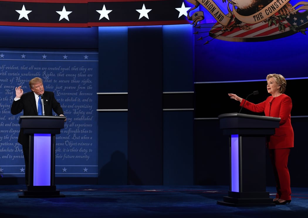 Republican presidential nominee Donald Trump, left, speaks as Democratic presidential nominee Hillary Clinton gestures at the debate at Hofstra University in Hempstead, New York.