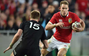 Lions player Liam Williams (R) runs towards New Zealand's Jordie Barrett.