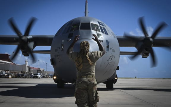 November 28, 2018 - U.S. Air Force specialist marshals a C-130J Super Hercules at the Saipan International Airport, Saipan, Commonwealth of the Northern Mariana Islands. (Photo by Stocktrek Images / StockTrek Images via AFP)