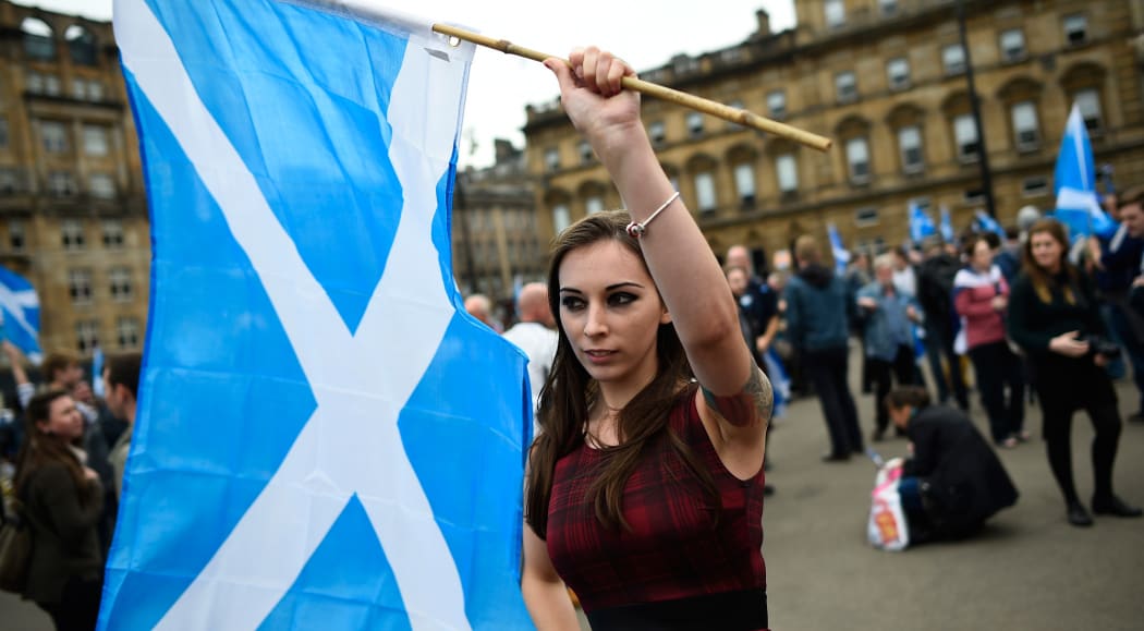 Waveing a Scottish Saltire at a "Yes" campaign rally in Glasgow.