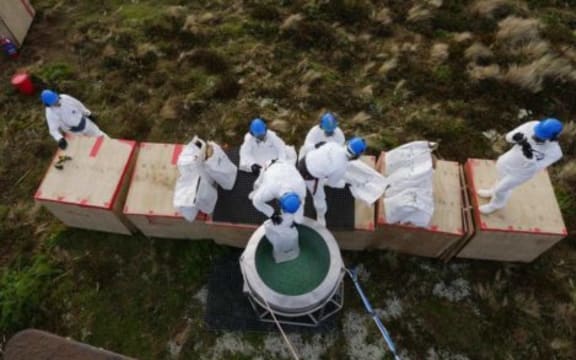 Loading a bait hopper.