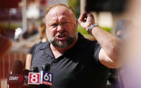 InfoWars founder Alex Jones speaks to the media outside Waterbury Superior Court during his trial on September 21, 2022 in Waterbury, Connecticut. Jones is being sued by several victims' families for causing emotional and psychological harm after they lost their children in the Sandy Hook massacre. A Texas jury last month ordered Jones to pay $49.3 million to the parents of 6-year-old Jesse Lewis, one of 26 students and teachers killed in the shooting in Newtown, Connecticut.