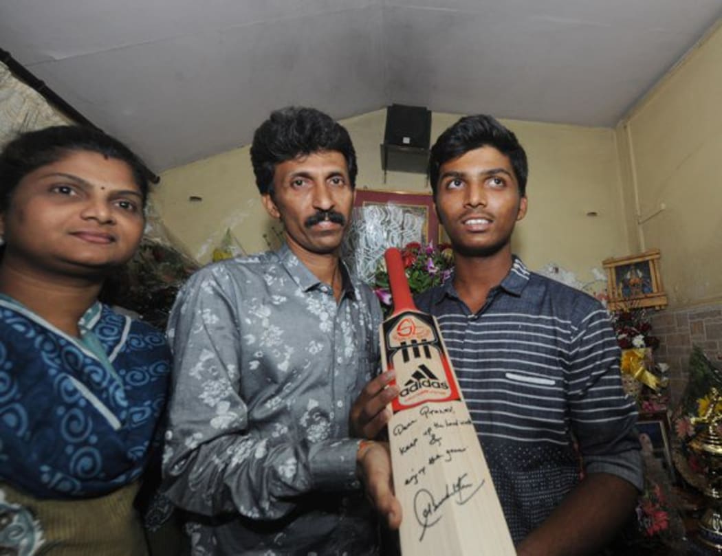 Pranav Dhanawade with his parents and the bat Sachin Tendulkar sent him.