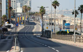 The pride flag decorates an empty street in Tel Aviv on 13 June, 2025, after the city's annual Pride Parade has been cancelled.