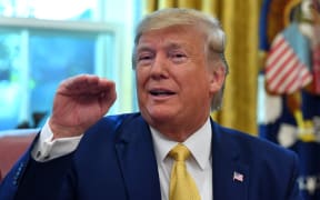 US President Donald Trump speaks after announcing an initial deal with China while meeting the special Envoy and Vice Premier of the People's Republic of China Liu He at the Oval Office of the White House in Washington, DC on October 11, 2019. -