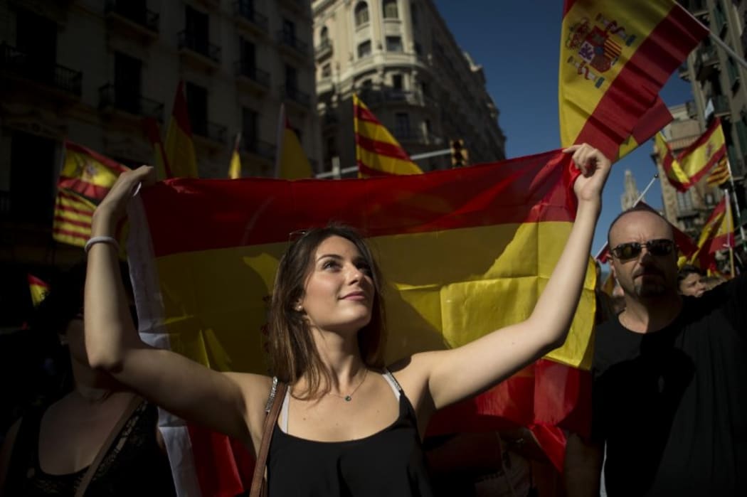 Tens of thousands of flag-waving demonstrators packed central Barcelona to rally against plans by separatist leaders to declare Catalonia independent following a banned secession referendum.