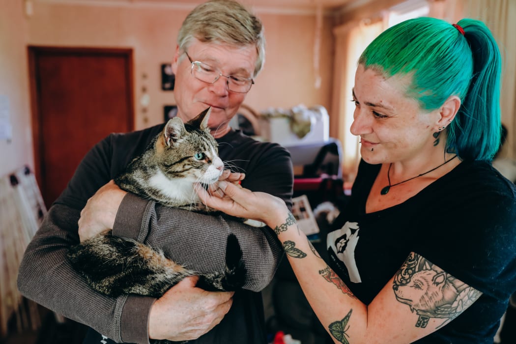 Thomas with his owner Alan Aaltonen and  Loose Leash Cat Rescue organiser Emjay Dette.