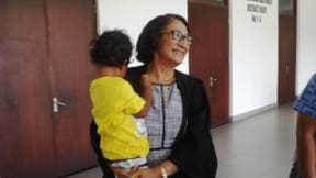 Leulua'ialii Olinda Woodroffe with the three-year-old child outside court in Samoa. The child was locked in a police cell when his father was arrested last year.