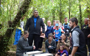 Ngāti Rereahu iwi member Tutahanga Tepu blesses the first robin before they are released.
