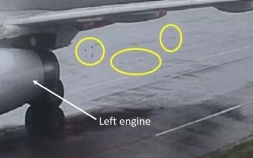 Foreign object debris on the ground behind the aircraft (circled).