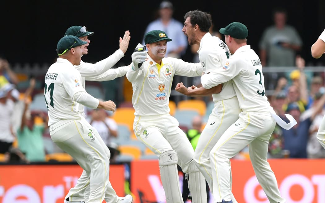 Australian bowler Mitchell Starc reacts after dismissing England batsman Rory Burns first ball of the day during day 1 of the First Ashes Test, 2021.