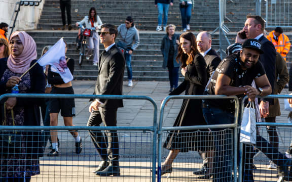 PM Jacinda Ardern (middle) and her partner Clarke Gayford walk in London during a day of meetings for Ardern, including with the UK PM Liz Truss and with King Charles.