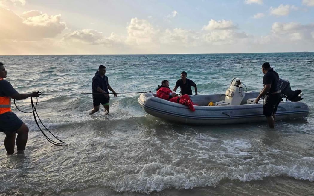 Samoa Fire and Emergency Services Authority staff rescue crew of the HMNZS Manawanui after it ran aground in Samoa.