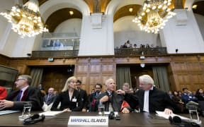 The Marshall Islands' delegation including lawyer Laurie B. Ashton (L), Luigi Condorelli (C) from the University of Florence and Phon van den Biesen (R), lawyer of the Marshall Islands' delegation) sit at the International Court of Justices (ICJ) in the Hague, on October 5, 2016.
