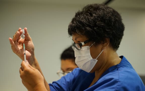 A vaccinator prepares one of New Zealand's first Covid-19 vaccinations on 19 February.