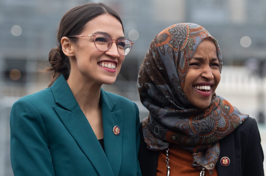 (FILES) In this file photo taken on February 7, 2019 US Representative Alexandria Ocasio-Cortez, Democrat of New York, and US Representative Ilhan Omar (R), Democrat of Minnesota,