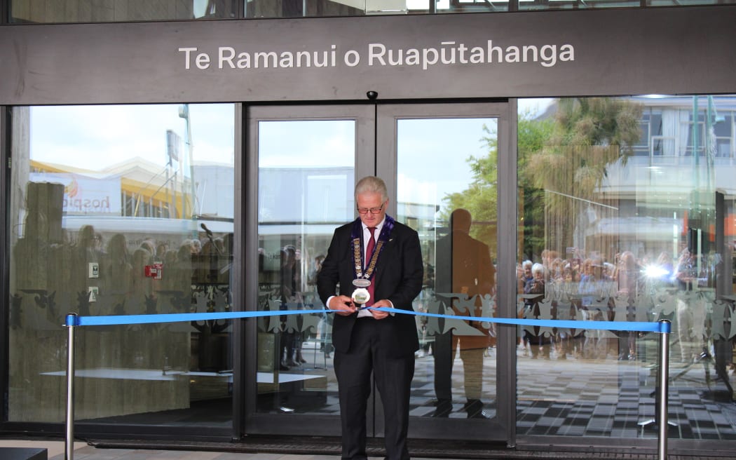 South Taranaki District Mayor Phil Nixon cuts a ribbon marking the opening Te Ramanui o Ruapūtahanga.