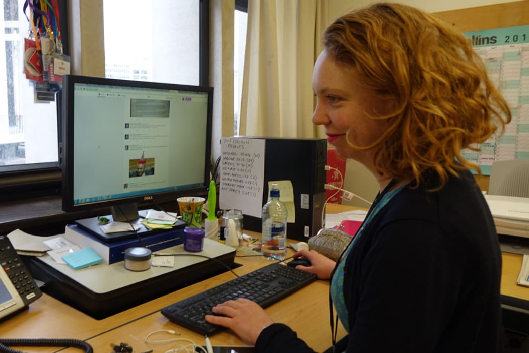 NZ Newswire reporter Sarah Robson multi-tasks by watching Parliament TV and checking twitter.