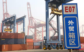 Cranes lift  containers at the Lianyungang Port, which is among the 10 largest ports in China  Lianyungang city, east Chinas Jiangsu province, 7 November 2020.
