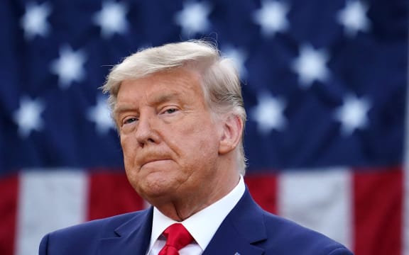 US President Donald Trump looks on after delivering an update on "Operation Warp Speed" in the Rose Garden of the White House in Washington, DC on November 13, 2020.
